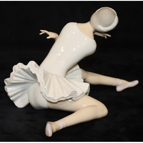 68 - A Lladro figure of a seated ballerina, 25cm long, 14cm high