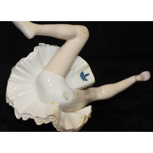 68 - A Lladro figure of a seated ballerina, 25cm long, 14cm high