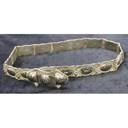 682 - An Eastern silver coloured panel bracelet with allover niello building decoration, 81cm long overall