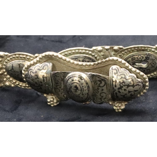 682 - An Eastern silver coloured panel bracelet with allover niello building decoration, 81cm long overall