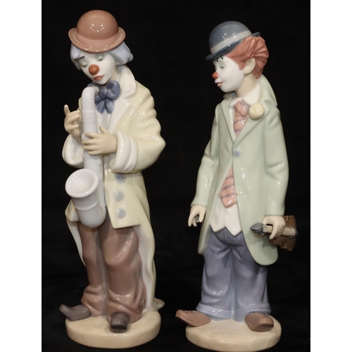 69 - 2 Lladro figures of clowns holding a violin and saxophone, largest 22cm high (2)