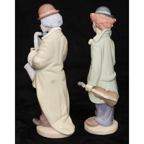 69 - 2 Lladro figures of clowns holding a violin and saxophone, largest 22cm high (2)