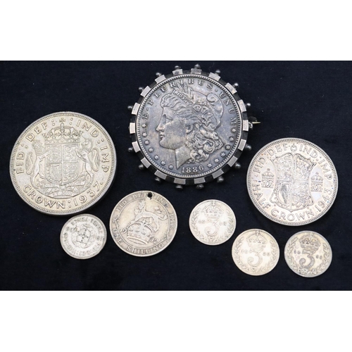 690 - An American $1, 1886, mounted in swivel pendant, a 1937 Crown, a 1943 Half Crown, a 1912 One Shillin... 