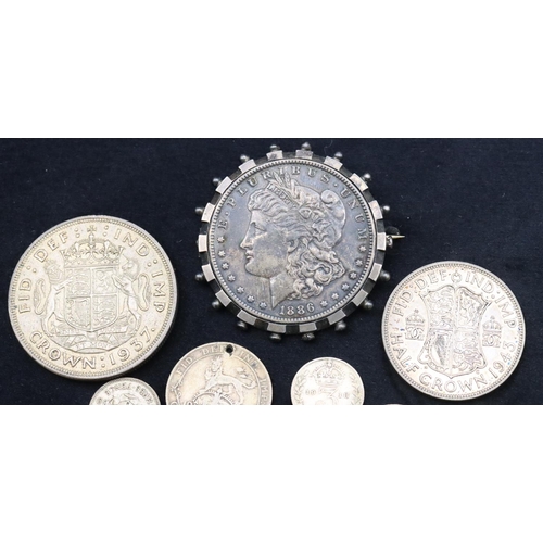 690 - An American $1, 1886, mounted in swivel pendant, a 1937 Crown, a 1943 Half Crown, a 1912 One Shillin... 