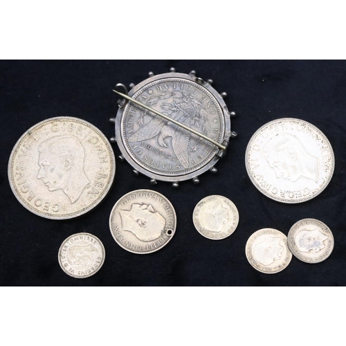 690 - An American $1, 1886, mounted in swivel pendant, a 1937 Crown, a 1943 Half Crown, a 1912 One Shillin... 