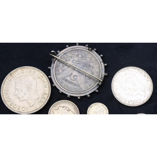 690 - An American $1, 1886, mounted in swivel pendant, a 1937 Crown, a 1943 Half Crown, a 1912 One Shillin... 