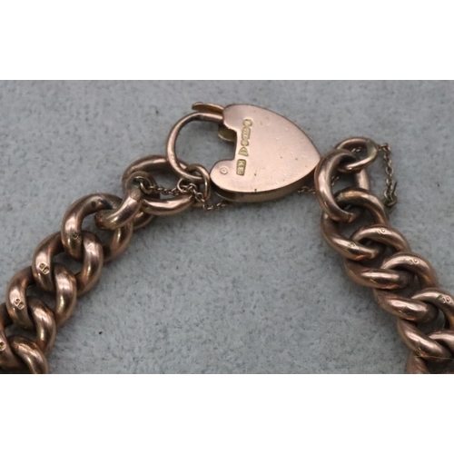 700 - A 9ct gold hollow linked bracelet with chased decoration and padlock clasp, 23.4 grams