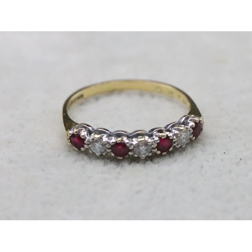 702 - An 18ct gold eternity ring set with 3 diamonds interspersed by 4 rubies, Size N/O, 2.3 grams gross