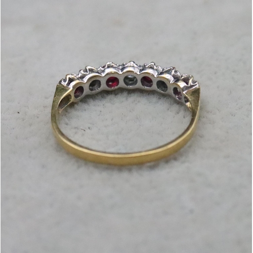 702 - An 18ct gold eternity ring set with 3 diamonds interspersed by 4 rubies, Size N/O, 2.3 grams gross