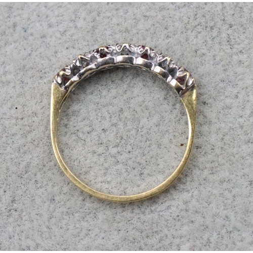 702 - An 18ct gold eternity ring set with 3 diamonds interspersed by 4 rubies, Size N/O, 2.3 grams gross