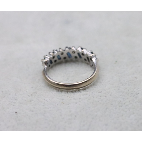 704 - An 18ct white gold ladies' half eternity ring set with baguette sapphires interspersed by small diam... 