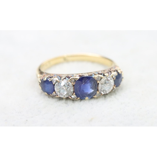 707 - An 18ct gold boat shaped ring set with sapphires interspersed by 2 diamonds, centre sapphires approx... 