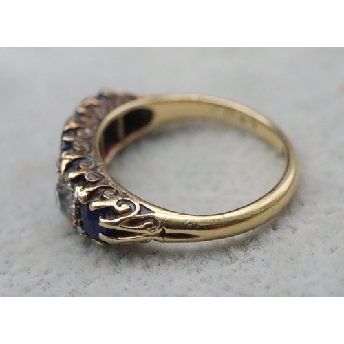 707 - An 18ct gold boat shaped ring set with sapphires interspersed by 2 diamonds, centre sapphires approx... 