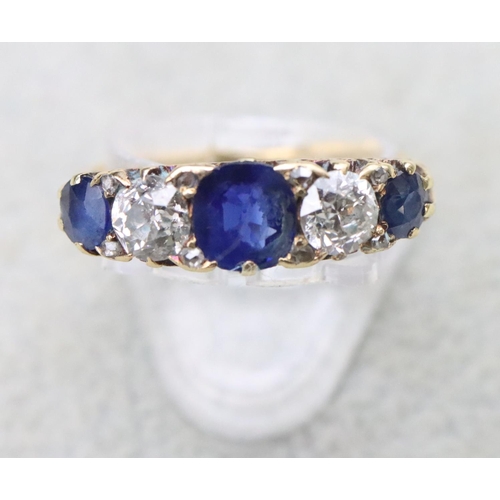 707 - An 18ct gold boat shaped ring set with sapphires interspersed by 2 diamonds, centre sapphires approx... 