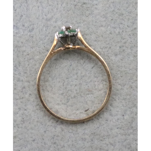 712 - A 9ct gold ladies' ring set with centre small diamond surrounded by emeralds, Size Q/R, 1.6 grams gr... 