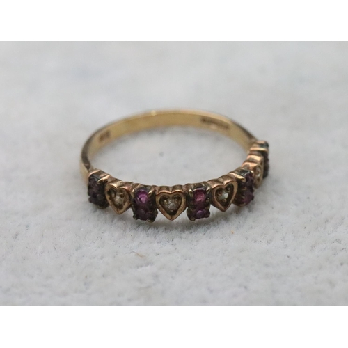 713 - A 9ct gold half eternity ring with 4 heart shaped motifs inset with small diamonds, interspersed by ... 