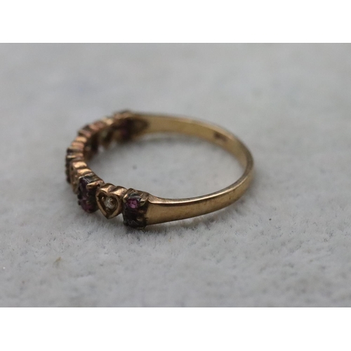 713 - A 9ct gold half eternity ring with 4 heart shaped motifs inset with small diamonds, interspersed by ... 