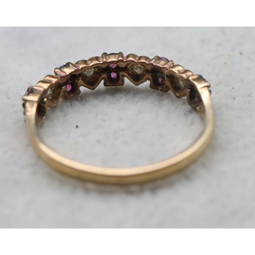 713 - A 9ct gold half eternity ring with 4 heart shaped motifs inset with small diamonds, interspersed by ... 