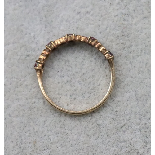 713 - A 9ct gold half eternity ring with 4 heart shaped motifs inset with small diamonds, interspersed by ... 