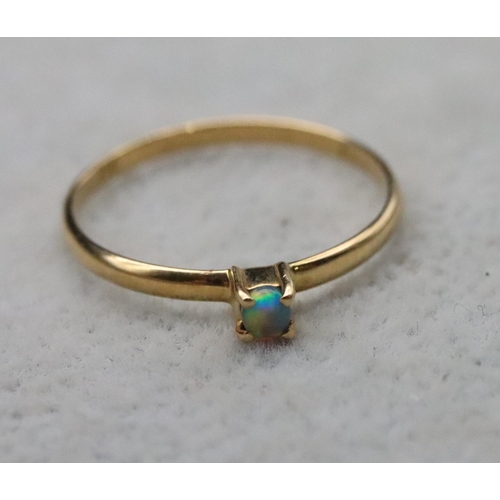 714 - An 18ct gold small black opal ring, Size L/M, 1 gram