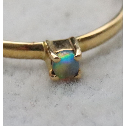 714 - An 18ct gold small black opal ring, Size L/M, 1 gram