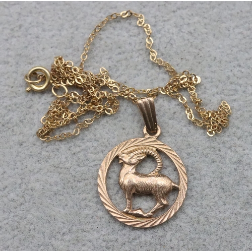 726 - A 9ct gold pendant with animal motif, with chain, 2.8 grams