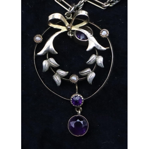 740 - A 9ct gold circular drop pendant mounted with amethysts and half pearls on 9ct gold long linked chai... 