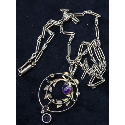 740 - A 9ct gold circular drop pendant mounted with amethysts and half pearls on 9ct gold long linked chai... 