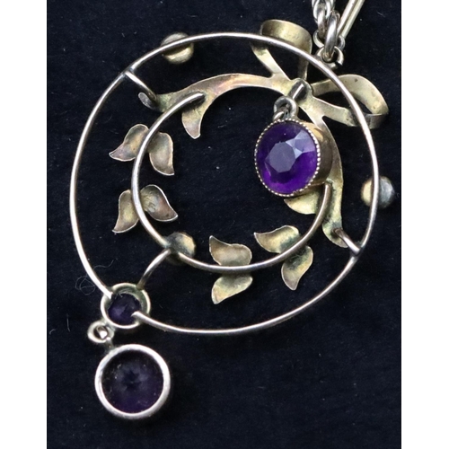 740 - A 9ct gold circular drop pendant mounted with amethysts and half pearls on 9ct gold long linked chai... 