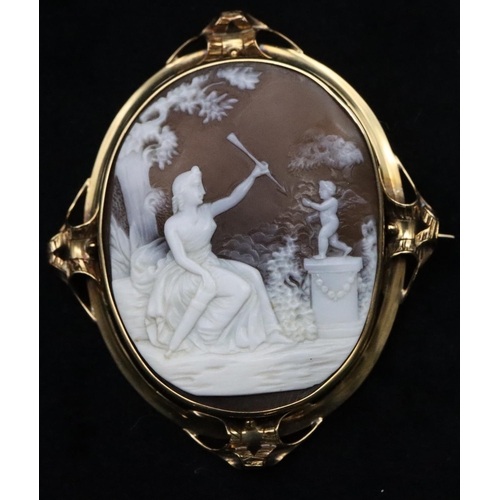 741 - A 19th Century cameo depicting a seated lady holding an arrow with cupid standing on plinth, in gold... 