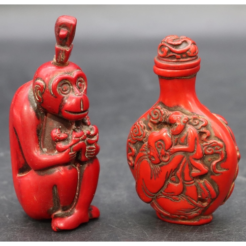 780 - A red lacquered scent bottle in the form of a seated monkey, 9cm high and another red lacquered scen... 