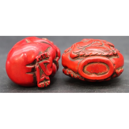 780 - A red lacquered scent bottle in the form of a seated monkey, 9cm high and another red lacquered scen... 