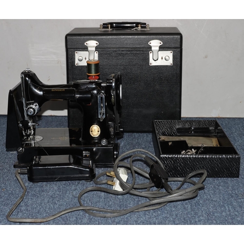 792 - A Singer portable electric sewing machine No. 221K1, with original box, instructions, spools etc.