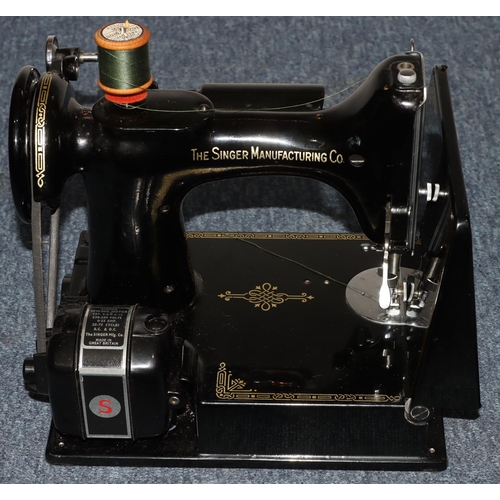 792 - A Singer portable electric sewing machine No. 221K1, with original box, instructions, spools etc.