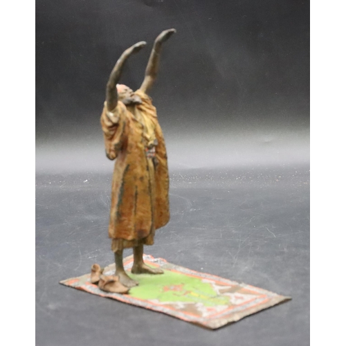 798 - A Venetian painted bronze figure of an Arabian man standing upon a carpet, 17cm high, 7.8cm wide, 14... 