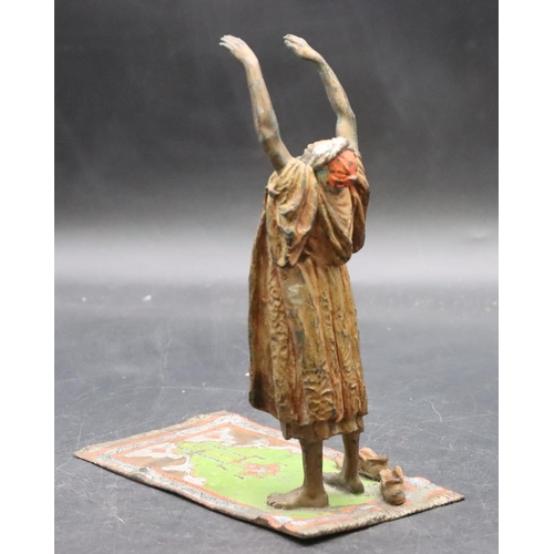 798 - A Venetian painted bronze figure of an Arabian man standing upon a carpet, 17cm high, 7.8cm wide, 14... 