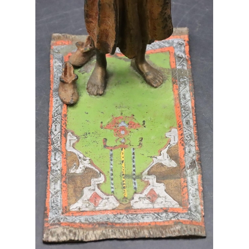 798 - A Venetian painted bronze figure of an Arabian man standing upon a carpet, 17cm high, 7.8cm wide, 14... 