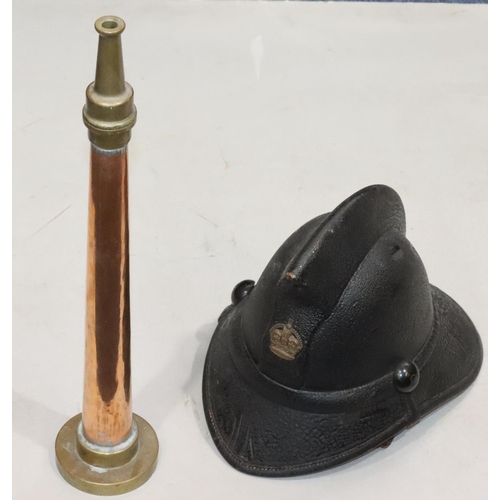 810 - An early leather Fireman's helmet, 23cm high and a Fireman's copper and brass nozzle, 48cm long (2)