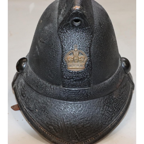 810 - An early leather Fireman's helmet, 23cm high and a Fireman's copper and brass nozzle, 48cm long (2)