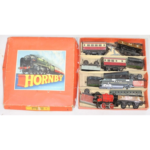 811 - A Hornby 0-Gauge railway set comprising of key wind engine, 10 various trucks and 2 x 00-Gauge carri... 