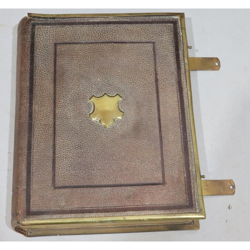 827 - A Victorian leather bound photograph album with brass mounts and clips, 18cm high (no photographs an... 