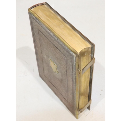 827 - A Victorian leather bound photograph album with brass mounts and clips, 18cm high (no photographs an... 