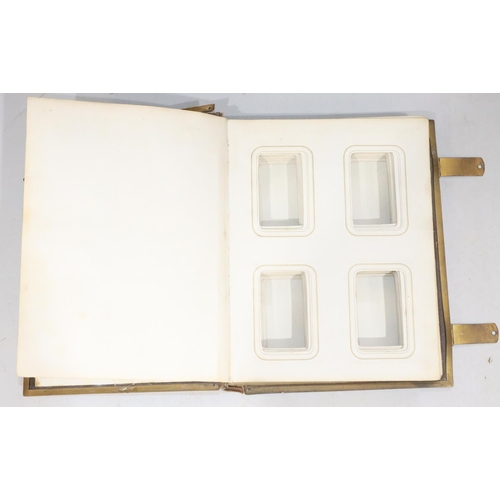 827 - A Victorian leather bound photograph album with brass mounts and clips, 18cm high (no photographs an... 