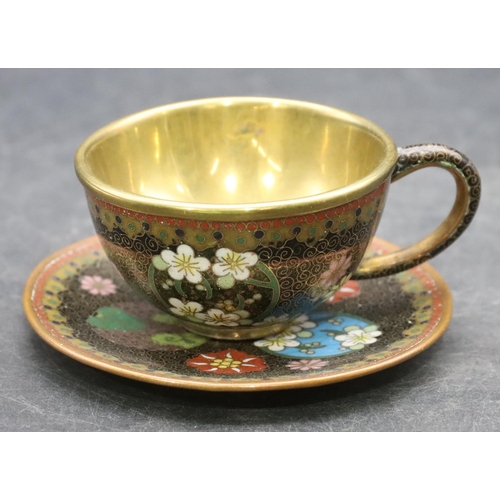 851 - A cloisonné small brass cup and saucer with multi-coloured floral, leaf and scroll decoration