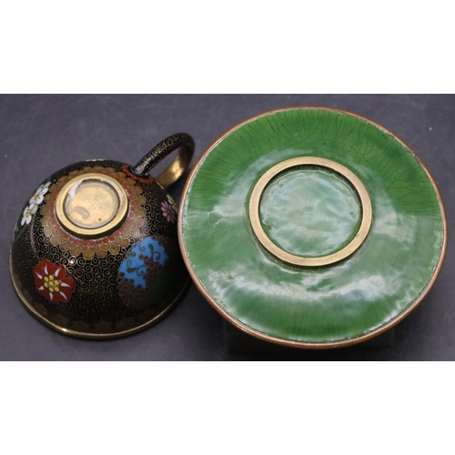 851 - A cloisonné small brass cup and saucer with multi-coloured floral, leaf and scroll decoration