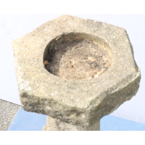 878 - A small concrete hexagonal bird bath on tapering base and square plinth, 62cm high, 31.5cm wide