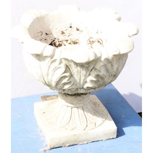 882 - A concrete round bulbous garden jardinière with scallop shaped rim and raised leaf decoration on spl... 