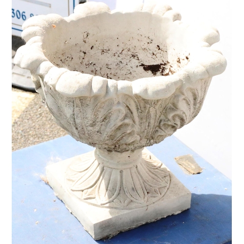 882 - A concrete round bulbous garden jardinière with scallop shaped rim and raised leaf decoration on spl... 