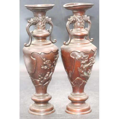 894 - A pair of Oriental bronze round bulbous thin necked 2-handled vases with raised bird, tree and flora... 