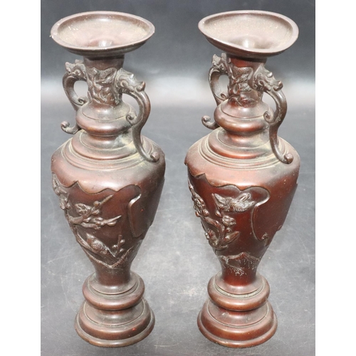 894 - A pair of Oriental bronze round bulbous thin necked 2-handled vases with raised bird, tree and flora... 